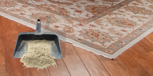 Dusting a rug for soil removal